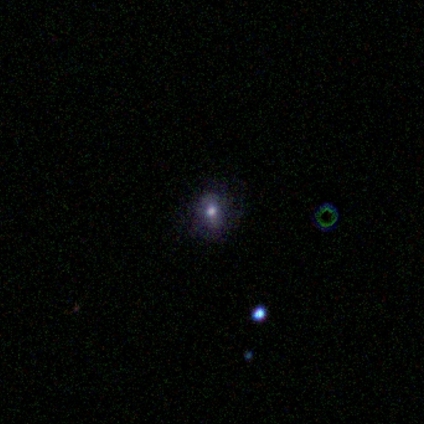 This image has an artifact (blue/green ring) to the right of the spiral galaxy.